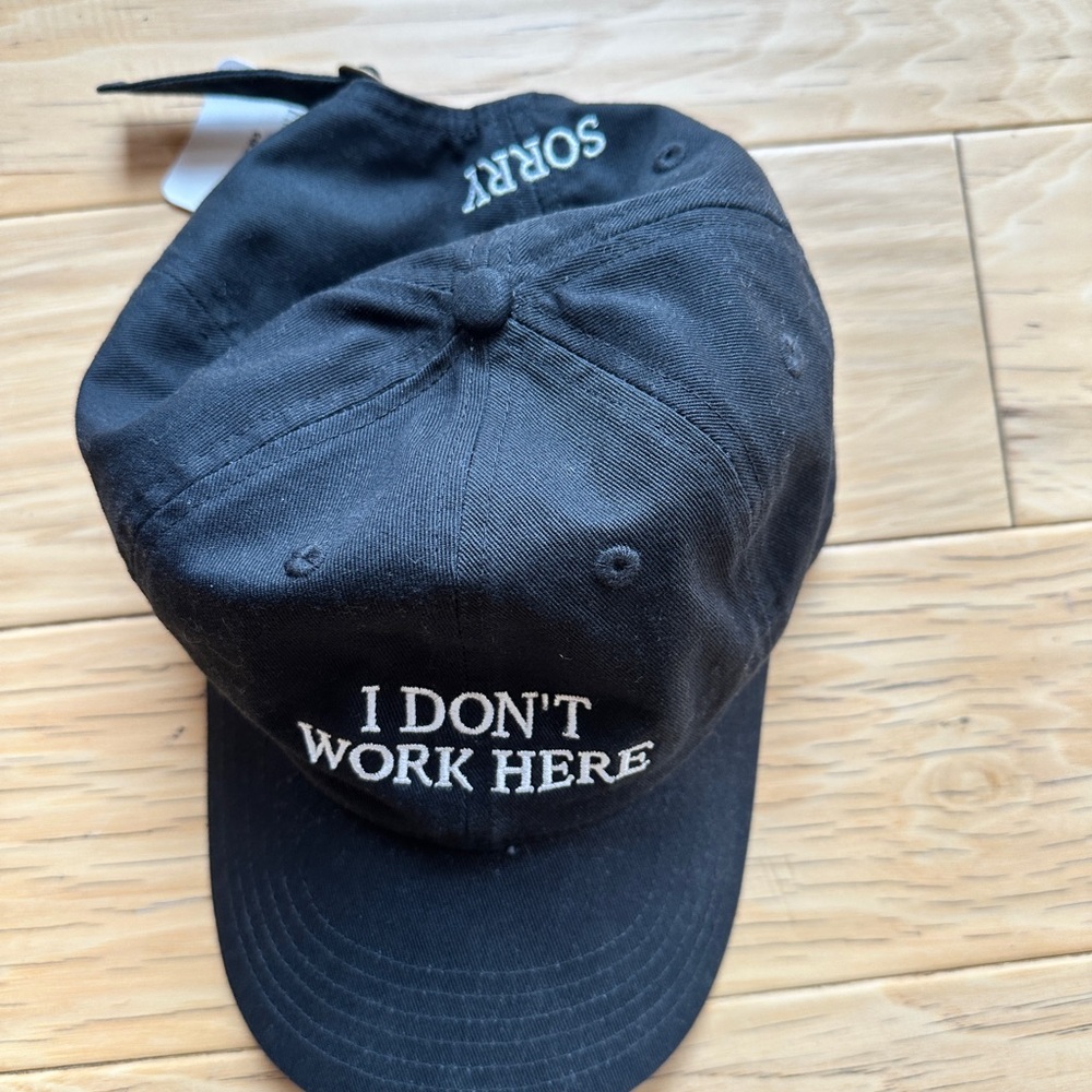 Black Adjustable Hat with “Sorry” “I Don’t Work Here” White Embroidery
